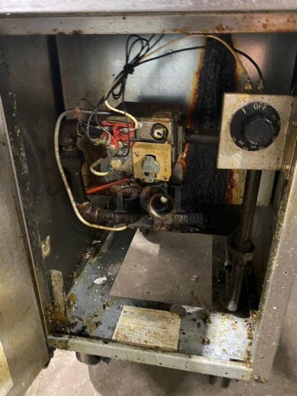 Frymaster GF40SC commercial fryer internals, stainless steel, natural gas, with rust and wear, shown on casters.
