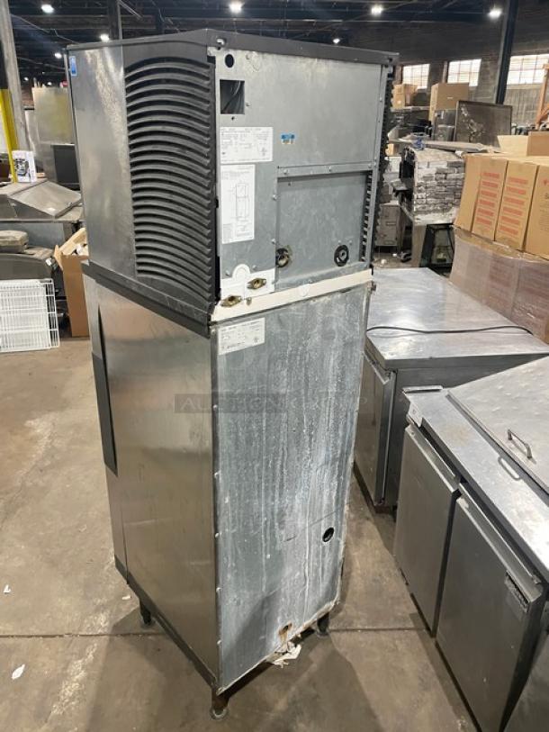 Manitowoc stainless steel ice machine and bin combo, model SD0423W/QPA160, electric water-cooled, on legs, in warehouse.