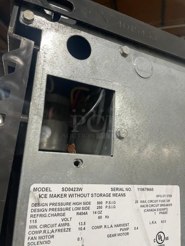 Manitowoc SD0423W ice maker model label, shows serial number 110679665, design pressure details, and UL certification.