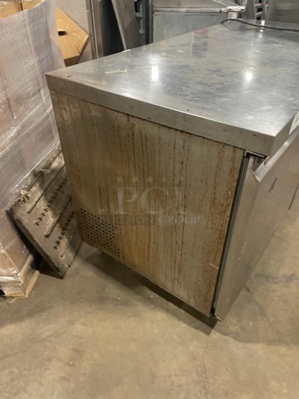 Avantco 2 Door Undercounter 60" Worktop Refrigerator, Model 178SSUC60RHC, stainless steel, on casters, visible rust and wear.