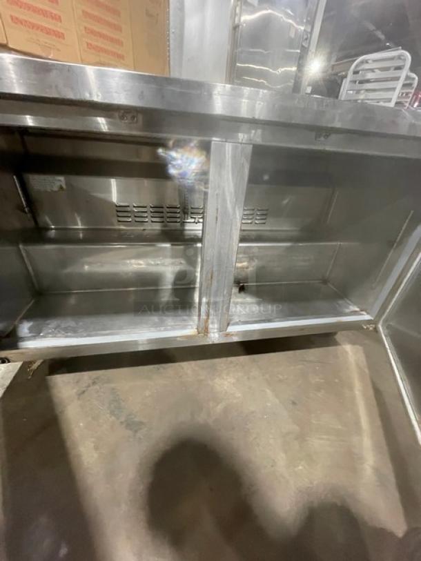 Avantco 2-door stainless steel undercounter refrigerator, model 178SSUC60RHC, on casters, showing interior condition.