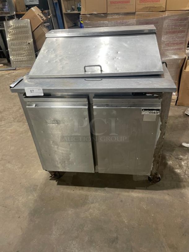 Cool-Tech stainless steel 2-door refrigerated 36" prep table, Model Custom36BMB, on casters, showing wear.