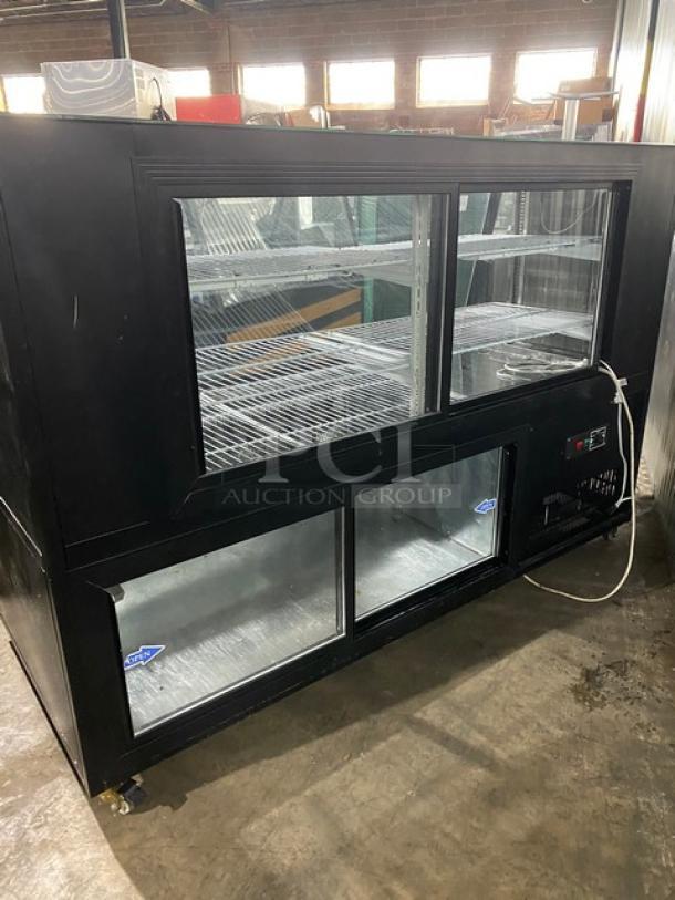 Commercial black 72" refrigerated deli merchandiser with slanted glass, dual rear glass sliding doors, wired racks, on casters.