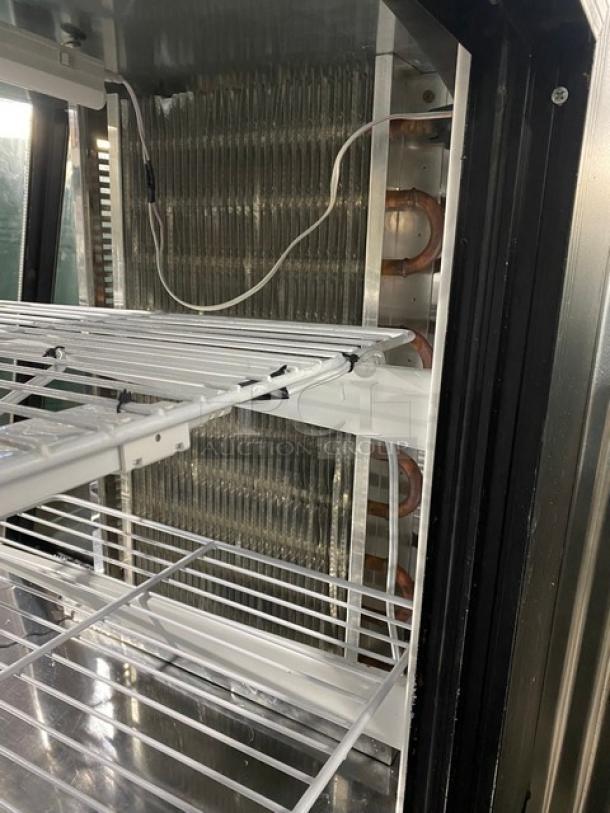 Commercial 72" black refrigerated deli case, slanted glass, dual glass sliding doors, poly coated racks, on casters.