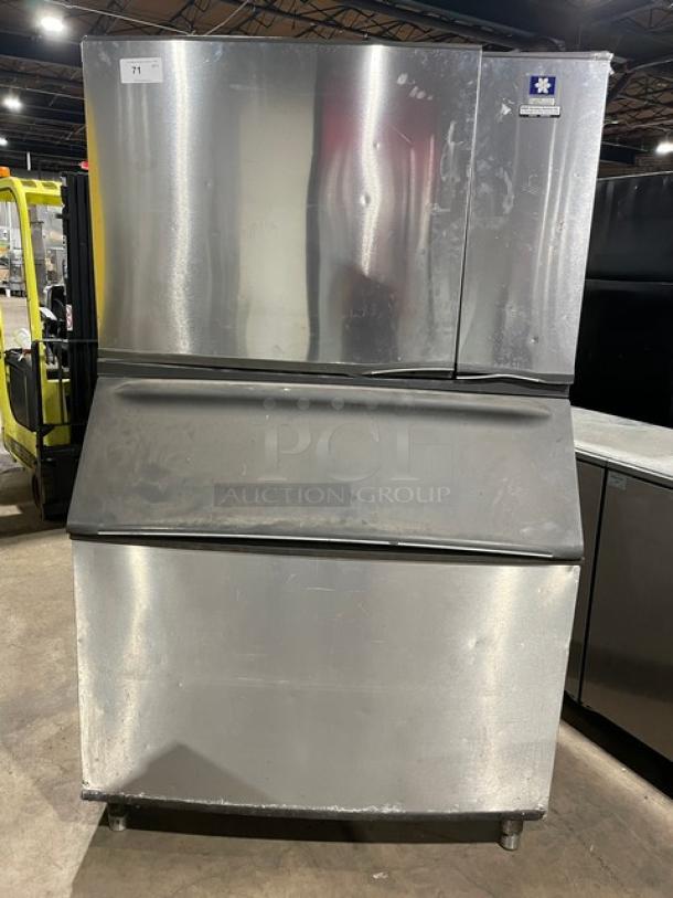 Manitowoc stainless steel ice maker SY1804A/B970, electric, air-cooled, on legs, lift-open lid, visible wear.