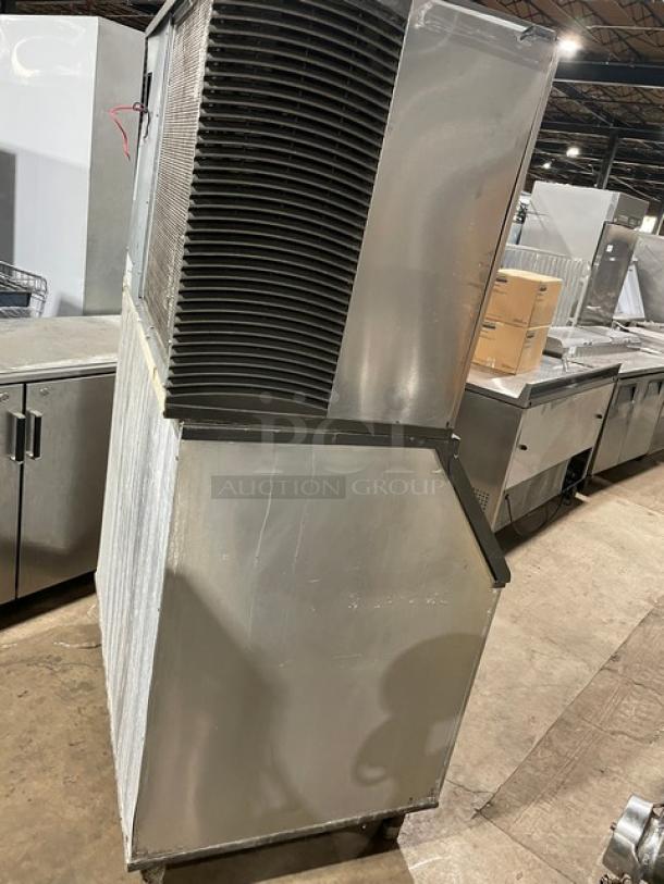 Manitowoc SY1804A/B970 ice machine, stainless steel, electric, air-cooled, lift-open lid, 208-230V, 1 phase, on legs.