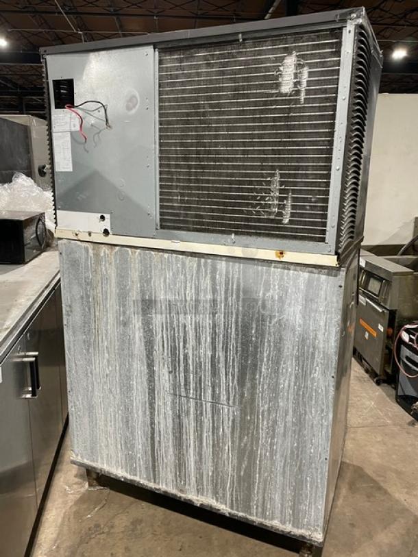 Manitowoc stainless steel ice machine, model SY1804A/B970. Air-cooled, electric-powered, on legs, lift-open lid.