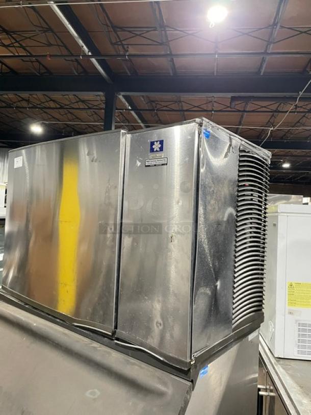 Manitowoc stainless steel ice machine SY1804A/B970, electric, air-cooled, lift-open lid, on legs, visible manufacturer label.