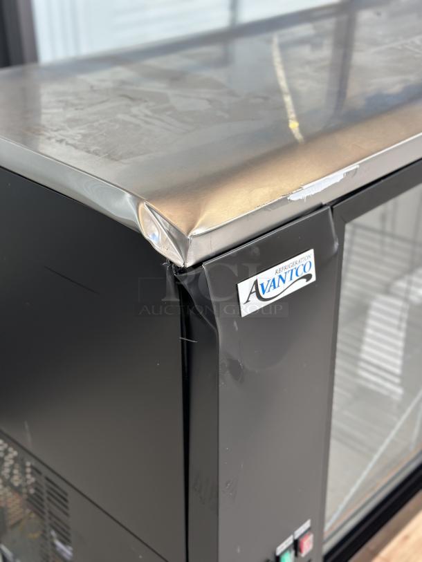 Avantco UBB-72S-HC bar refrigerator with sliding glass doors, black finish, crushed front top edge, door misaligned, LED lighting.