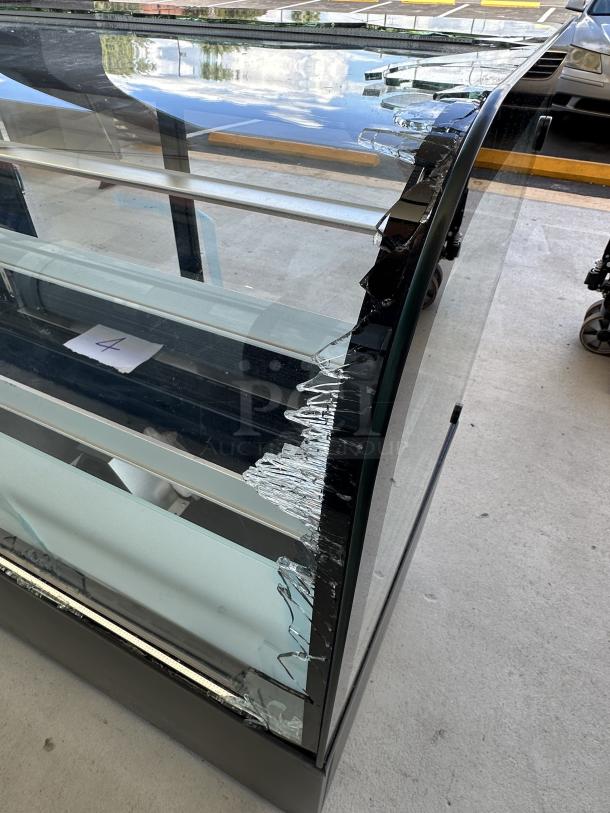 Avantco BCD-48 curved glass bakery display case, 48", black, scratch and dent; broken glass visible. Model: 193BCD48B.