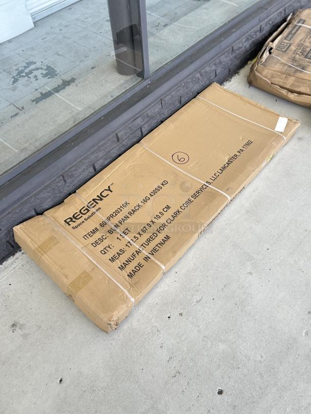 Brand new Regency 20 Pan Rack, model 600PR20316K, unassembled, in original packaging marked "scratch and dent."