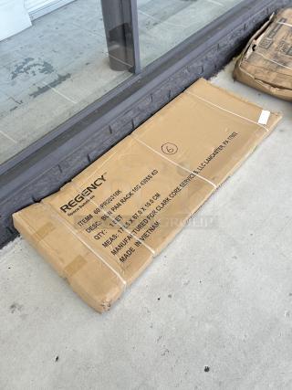 Brand new Regency 20 Pan Rack, model 600PR20316K, unassembled, in original packaging marked "scratch and dent."