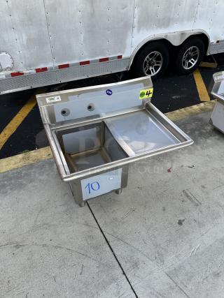 Regency 600S1162018R sink component, brand new with scratch and dent. Features right drainboard and visible labeling.