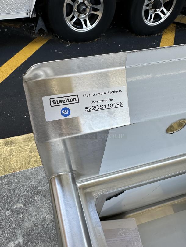 Steelton 23 1/2" stainless steel commercial sink, model 522CS11818N, 18-gauge, new condition with minor dents, NSF certified.