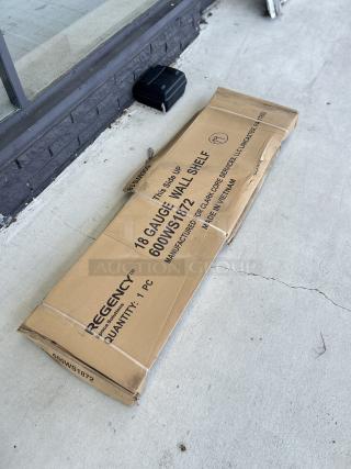 Regency 18x72 inch stainless steel wall shelf, model 600WS1872, in packaging. Scratch and dent condition.