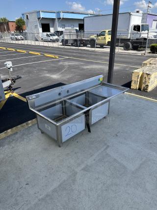 Regency 600S2242424R two-compartment commercial sink with right drainboard. Brand new, minor scratches visible.