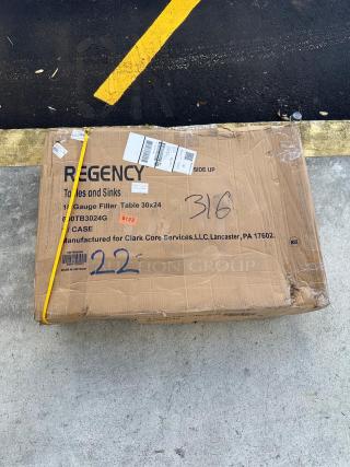 Cardboard box labeled "Regency Tables and Sinks," containing a Regency 30"x24" stainless steel table model 600TB3024G.