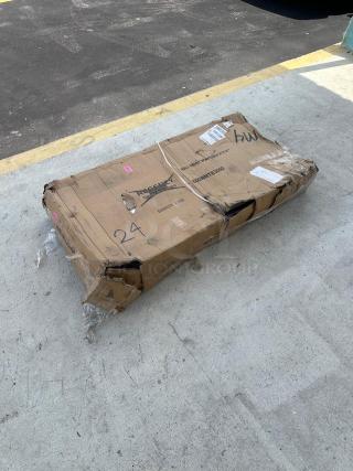 Cardboard box with visible damage, labeled "Regency 600WMTB3060" for a 30"x60" stainless steel table, shows shipping wear.