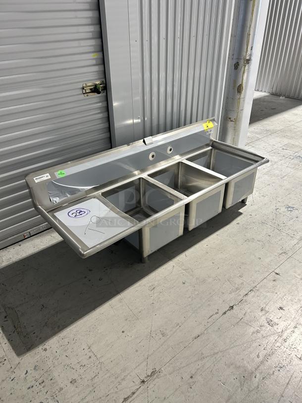 Brand new Regency 3-compartment sink model 600S3162018L with 16"x20"x18" bowls, left drainboard, minor scratches.