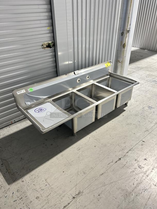 Brand new Regency 3 compartment sink, model 600S3162018L, with 16"x20"x18" bowls and left drainboard, scratch and dent.