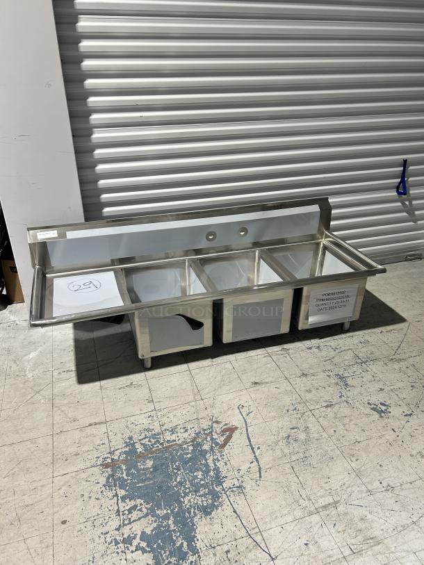 Regency 3-compartment sink, model 600S3162018L, with left drainboard; new, scratch and dent condition.