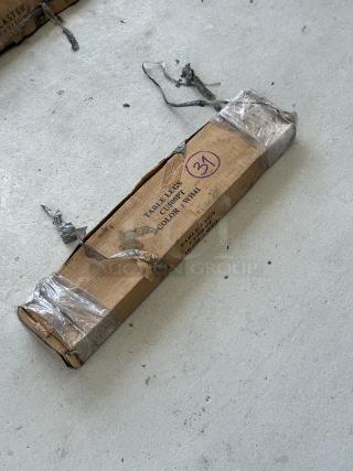 Brand new table legs in a scratched and dented box, color WH41, packaging taped with visible wear, marked "31".