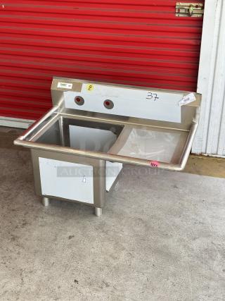 Brand new Regency sink, model 600S1181818R, with right drainboard. Visible scratch and dent, labeled for reference.