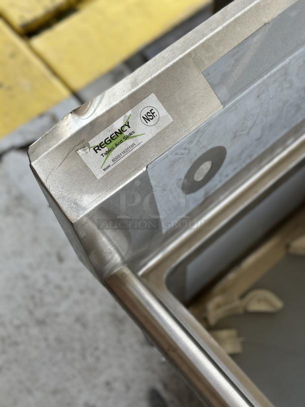 Brand new Regency Sink with right drainboard, model 600S1181818R. Scratch and dent condition. NSF certified label visible.