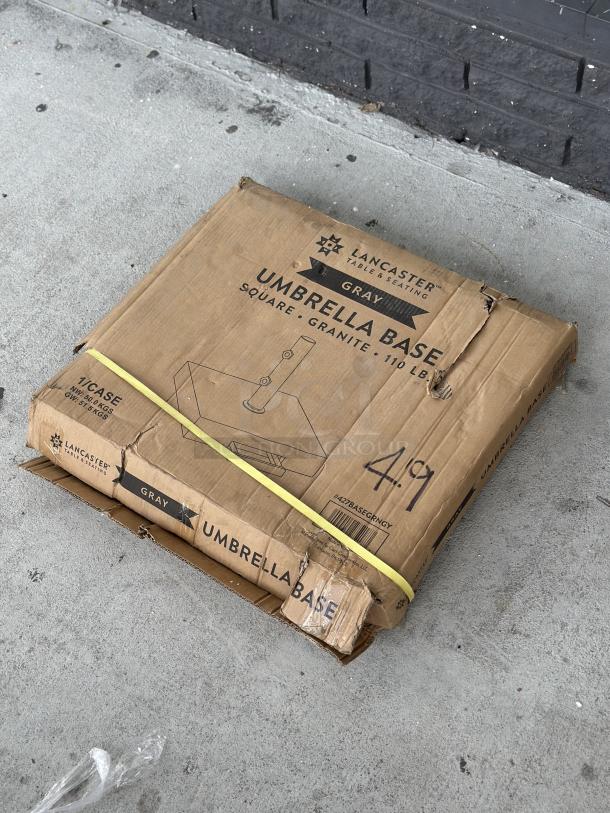 Brand new Lancaster Table & Seating 110 lb. gray square granite umbrella base in original packaging; model 427BASEGRNGY.