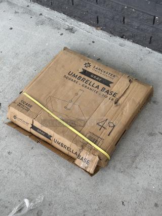 Brand new Lancaster Table & Seating 110 lb. gray square granite umbrella base in original packaging; model 427BASEGRNGY.