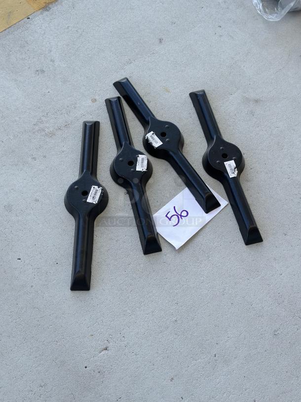 Brand new straight cast iron table base plates, 5"x22", with labels attached, shown on concrete surface. Set of four.