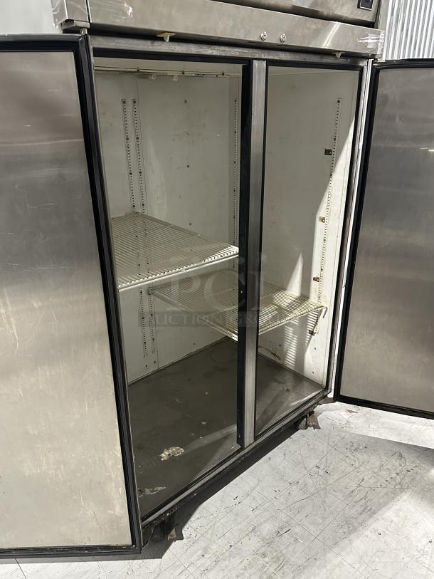 USED True Refrigerator, Model 3025342. Two sections, visible wear, open doors, two interior shelves. Brand: True.