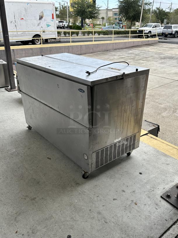 USED Norlake School Milk Cooler, stainless steel, on wheels, visible wear; plug and Norlake logo visible.
