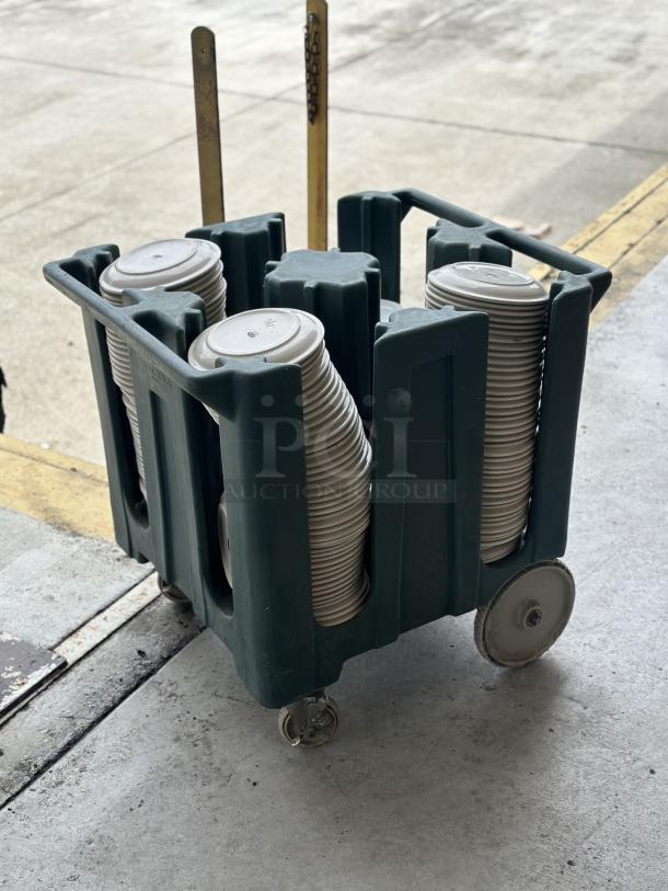 Used Superior ceramic plates, 9"-10", stacked in a green transport cart on wheels, in good condition.