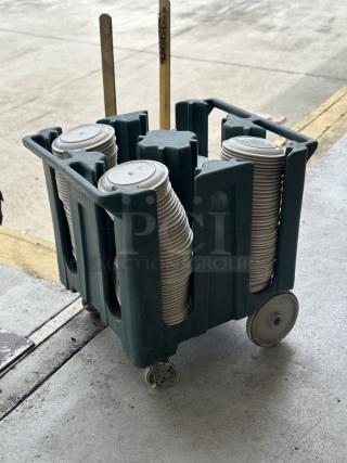 Used Superior ceramic plates, 9"-10", stacked in a green transport cart on wheels, in good condition.
