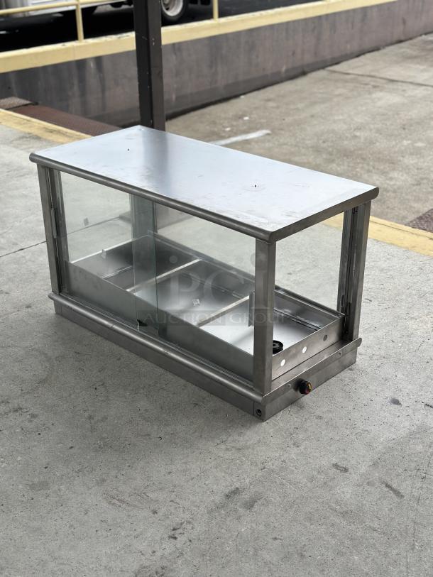 Used food display warmer case with glass panels, metal frame, and adjustable temperature control. Visible signs of wear.