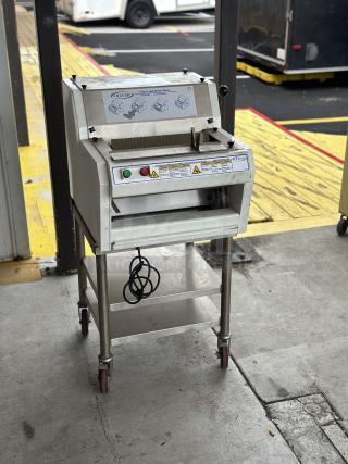 USED Oliver front load bread slicer with stand, visible control buttons, and casters; shows manufacturer and safety labels.