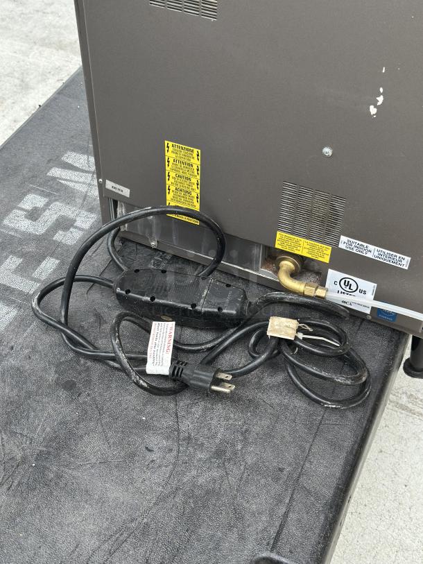 Back of a Krea Touch Necta coffee machine showing condition and electrical connections, used, with warning labels visible.