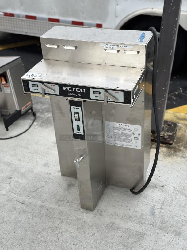 USED Fetco CBS-52H automatic coffee brewer, 120/208-240V, stainless steel, visible control panel, signage for operation.