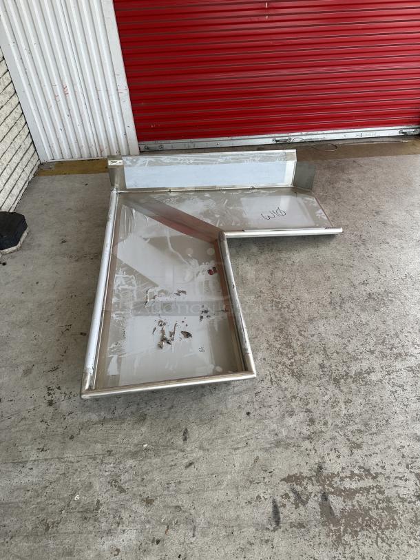 Brand new Regency 6' L-shape dishtable, 16-gauge stainless steel with visible scratches and dents.