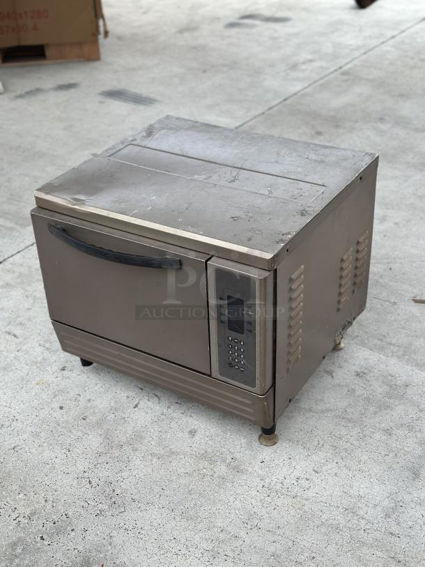 USED Turbochef oven, visible wear, digital control panel, sturdy handle, suitable for rapid cooking needs.