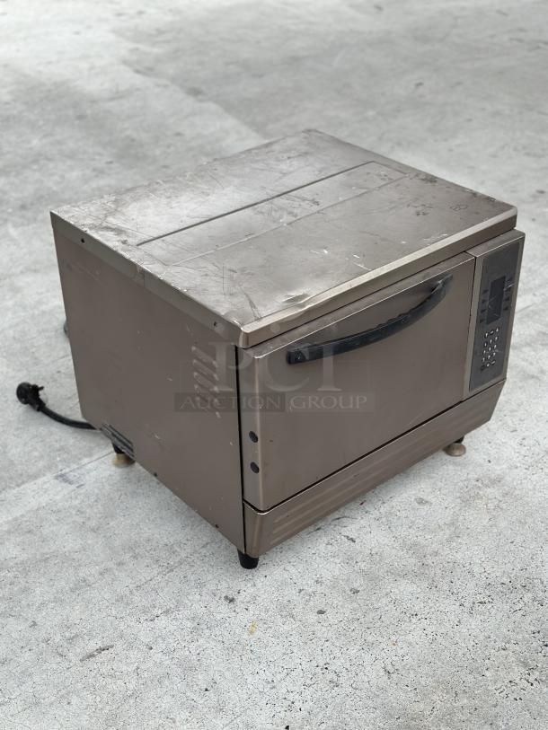 Used TurboChef oven, stainless steel, with visible wear, digital control panel, and power cord attached.