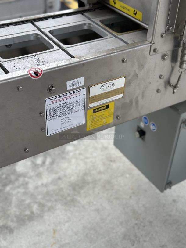 USED Oliver Speedseal MX 1808 Automated Packaging System, visible maintenance checklist and caution labels, good condition.