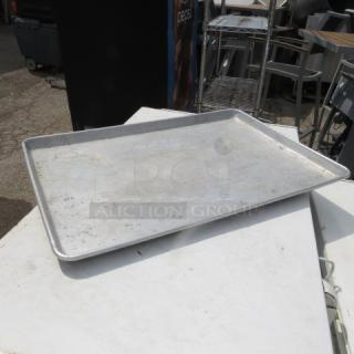 Full size aluminum sheet pan, used condition, minor surface wear, ideal for commercial baking or catering.
