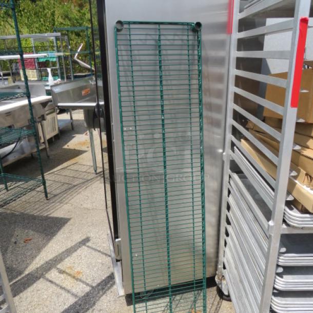 Green Metro shelf, 60x14 inches, sturdy wire construction. Appears in good condition, suitable for storage use.