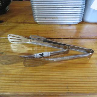 Stainless steel tongs, 2xBID. Slotted tips, excellent condition, reflective finish, approximately 12 inches long.