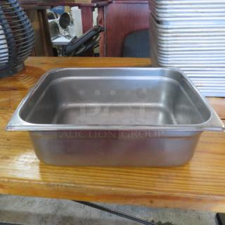 Stainless steel 1/2 size 4-inch deep hotel pan, used condition, clean surface, suitable for food service.