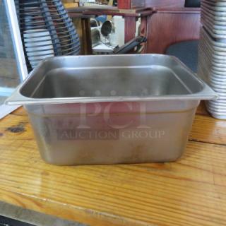1/2 Size 6-Inch Deep Hotel Pan, stainless steel, used condition, suitable for food service, showing slight wear.