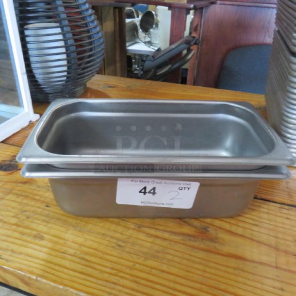 Stainless steel 1/3 size, 4-inch deep hotel pan, new condition, with auction label "44" visible on the side.