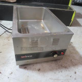 Winco food warmer, model FWS6001, 120V. Stainless steel, used condition, visible control knob and branding.